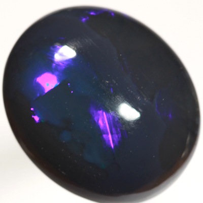 SOLID BLACK OPAL Huge opal with rolling flashes of electric blue. SEE VIDEO